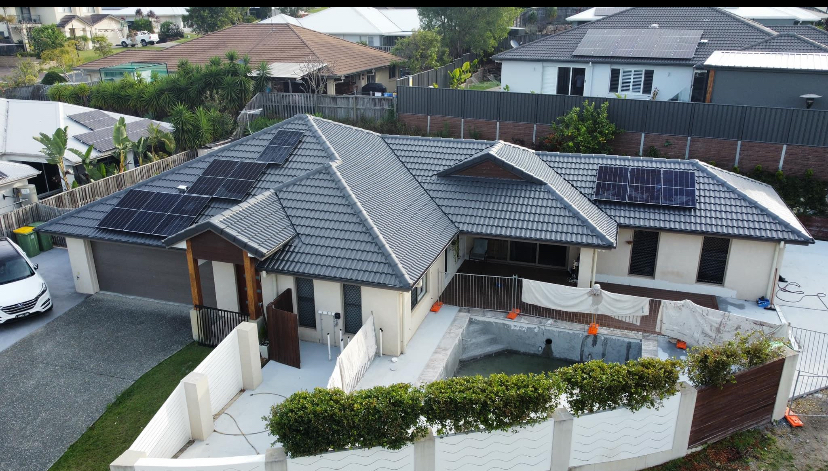Single-storey home with a charcoal tiled roof and white rendered walls